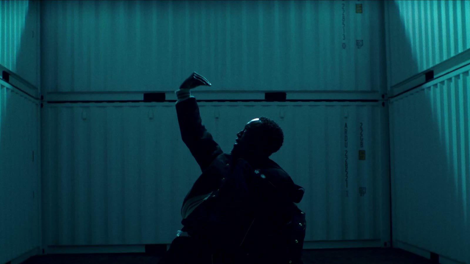 Music production for video production companies: a dancer in a teal shipping container, a scene from the Banlieue film with our music and sound design