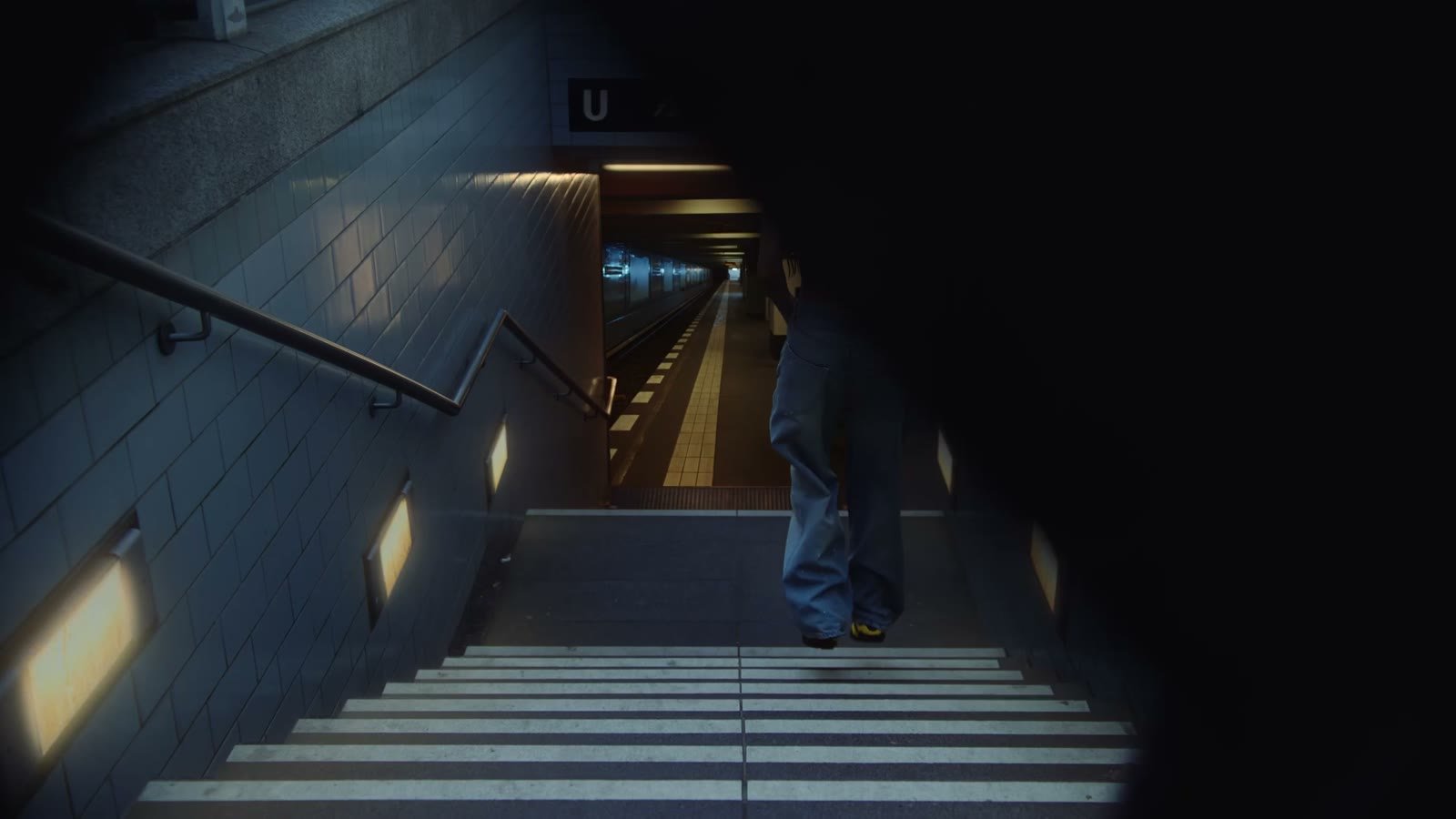 Sonic branding agency in Amsterdam: someone walking down the stairs to a metro platform in a Puma campaign video